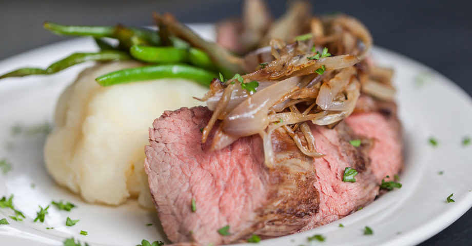 Delicious beef dish with mashed potatoes and green beans.