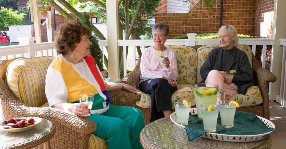 Three ladies enjoying lemonade on the front porch.