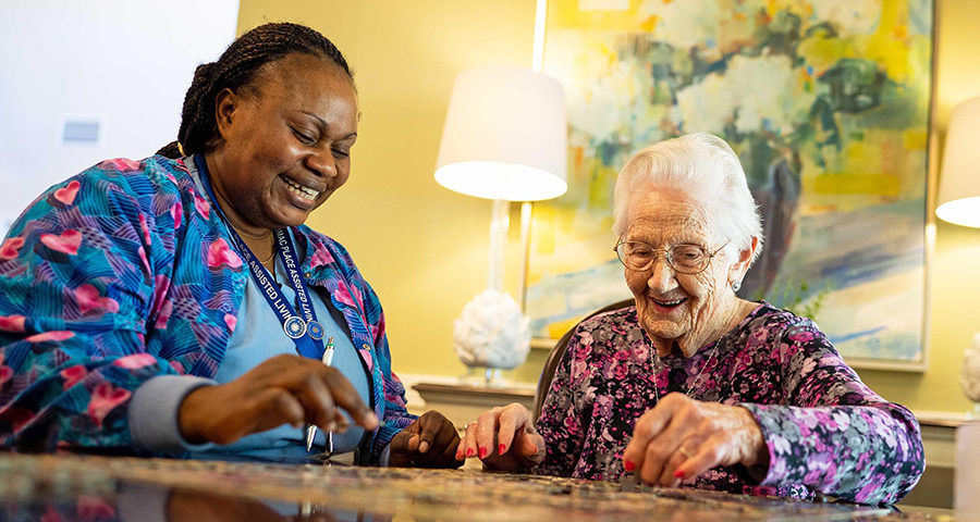 resident and caregiver doing puzzles