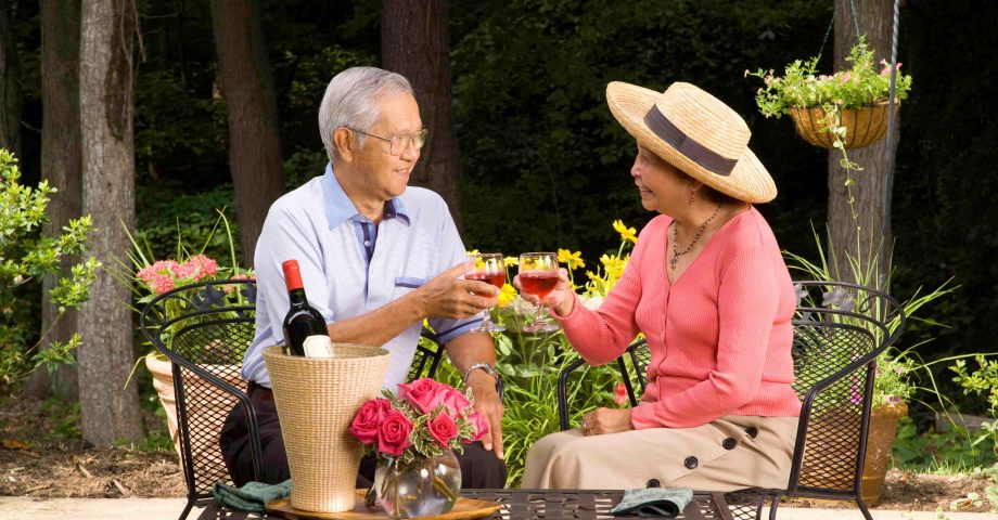 senior Asian couple having a glass of wine