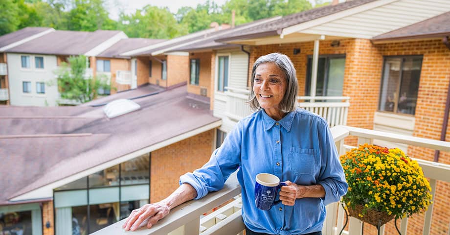 Woman on Apartment Balcony | Assisted Living Residents